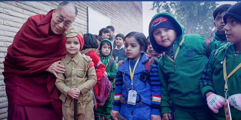 His Holiness the Dalai Lama with a group of Children. Photo: screenshot from video of Finding Peace of Mind