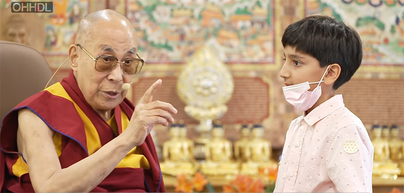 His Holiness the Dalai Lama with a young boy, on April 11, 2022.