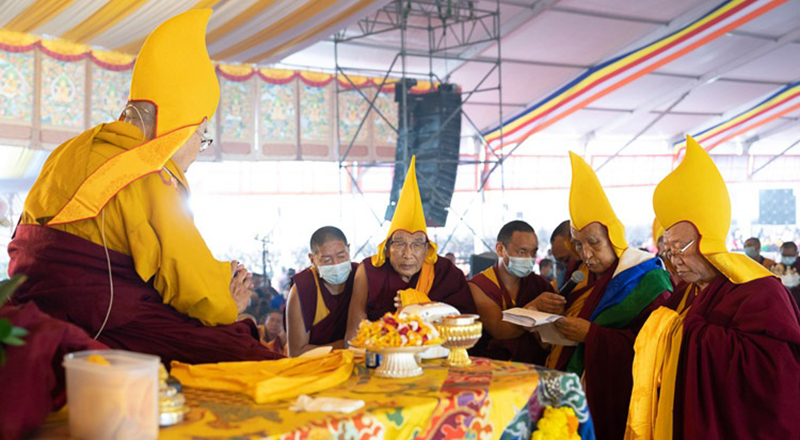 Gaden Tri Rinpoché reading a tribute reviewing His Holiness the Dalai Lama’s life and requested him to live long during the Long Life Prayer at the Kalachakra Teaching Ground in Bodhgaya, Bihar, India on January 1, 2023. Photo: Tenzin Choejor